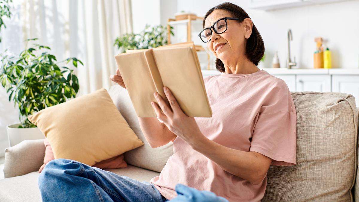 Mature woman in homewear, sitting on couch