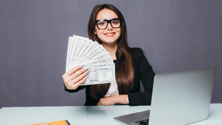 Portrait of happy business woman with money in hand