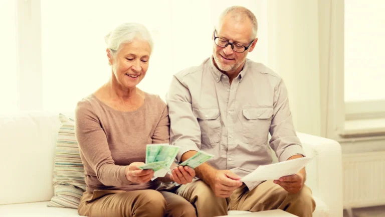 Senior couple with money and calculator at home