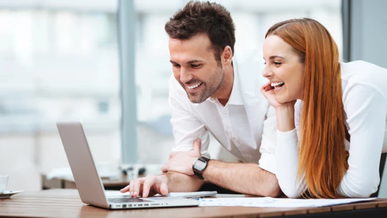 Two professionals looking at laptop