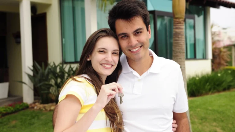 Couple standing outside new house