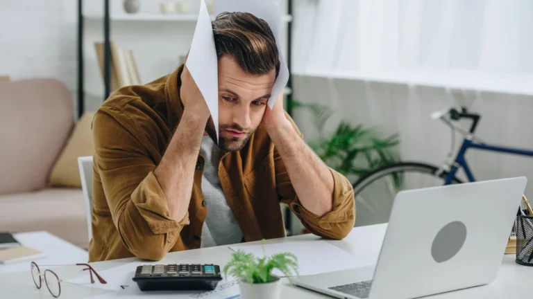 Handsome and sad man in shirt holding papers