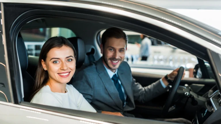 Selective focus of pretty woman sitting in car