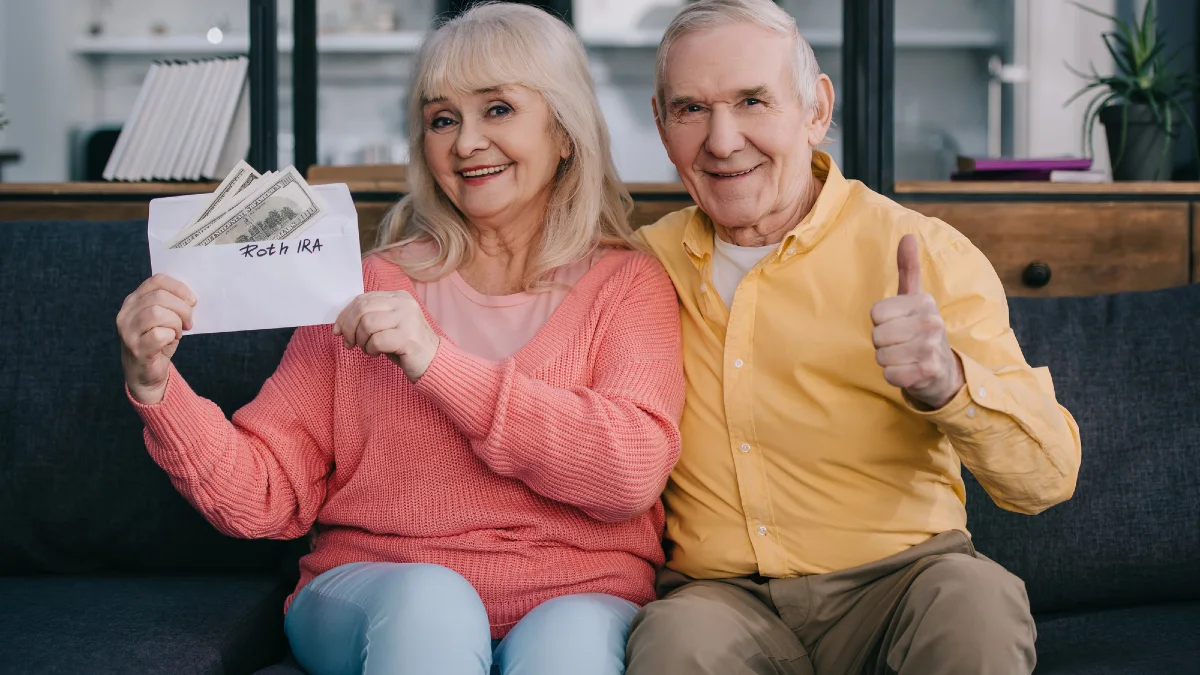 Senior couple showing thumb up sign while holding