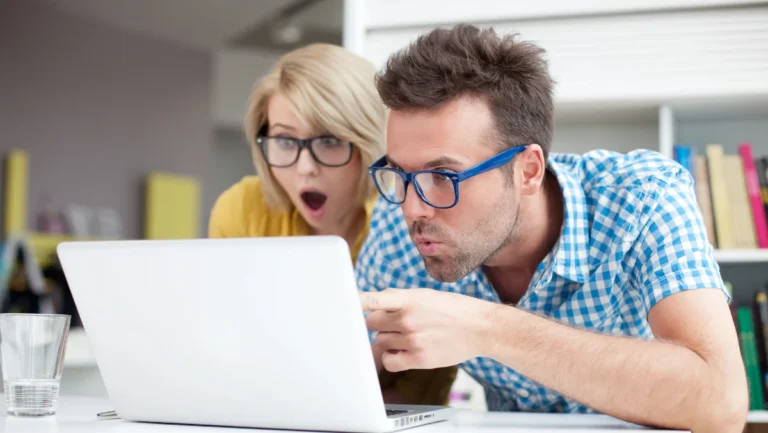 Two surprised students learning in library