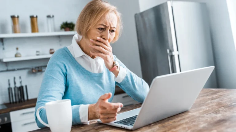 Upset senior woman covering mouth with hand