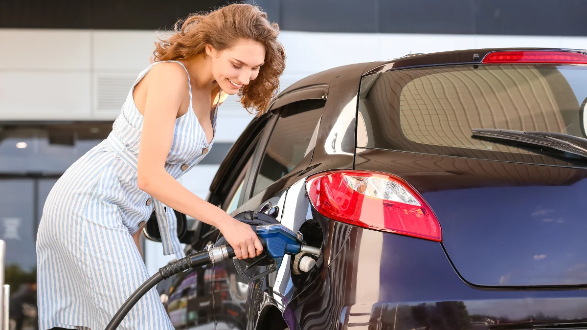 Woman refueling car on petrol station