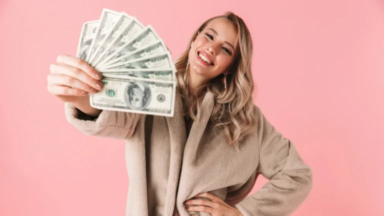 Young pretty woman posing isolated over pink wall background