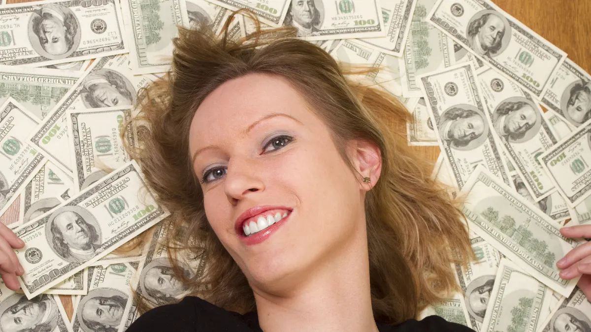 Young woman with her head lieing on the dollars
