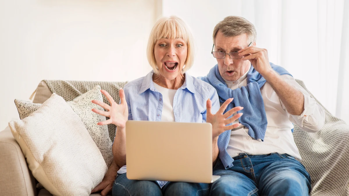 Surprised mature couple winning online auction