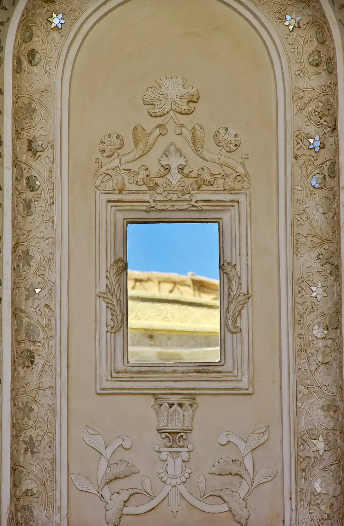 Ornate Stone Arch Mirror with Classical Detailing