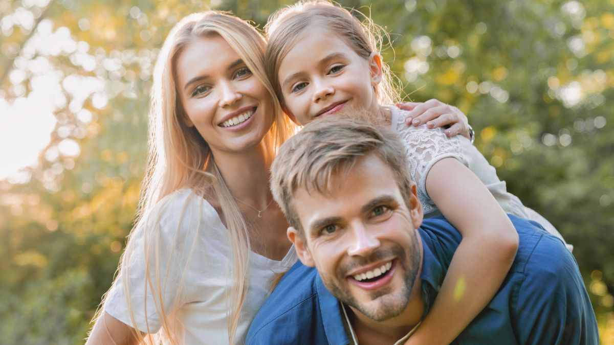 Young couple smiling outside