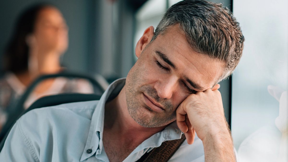 Man taking a nap on the bus